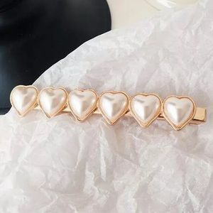 Gold finish and faux heart shaped pearl hair clip